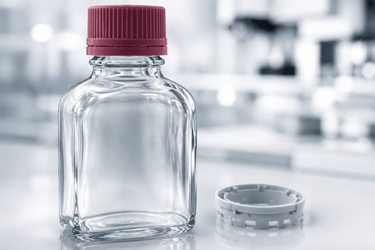 Pharmazeutischer Glasbehälter mit rot hervorgehobenem Schraubverschluss und separater Verschlusskomponente
